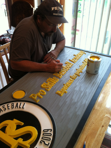 Mark painting a sign