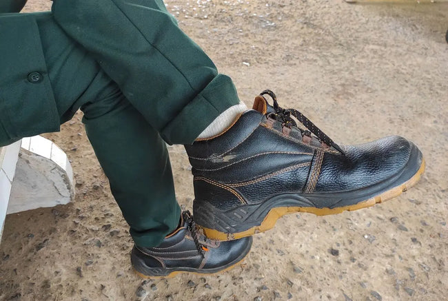 man in black work boots with metatarsal protection