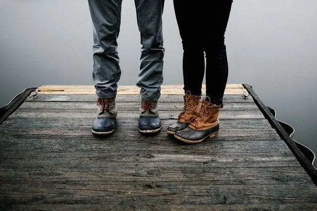 a couple standing in rubber-soled boots on a raft