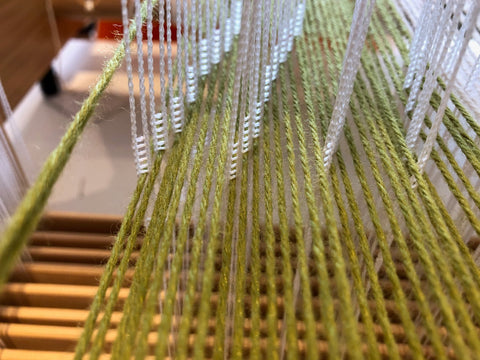 Warp yarn going through individual heddles