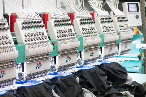embroidery machine with custom polos on it