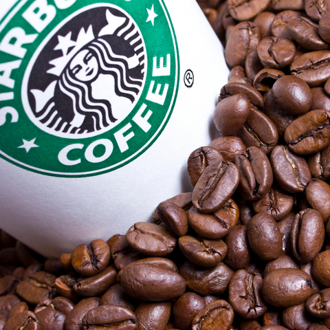 Starbucks coffee cup in coffee grounds