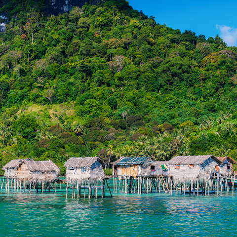 Sea Bajau hut in water in front of mountain