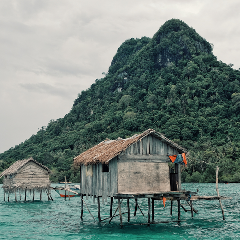 Sea Bajau hut in front of mountain