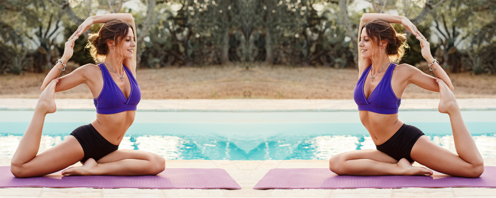 Mermaid pose yoga pool side women