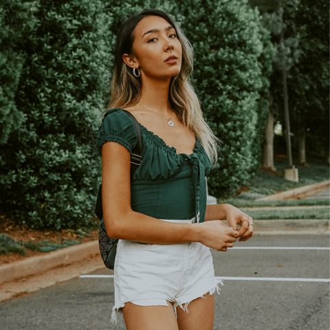 Woman wear white jean shorts and green crop top