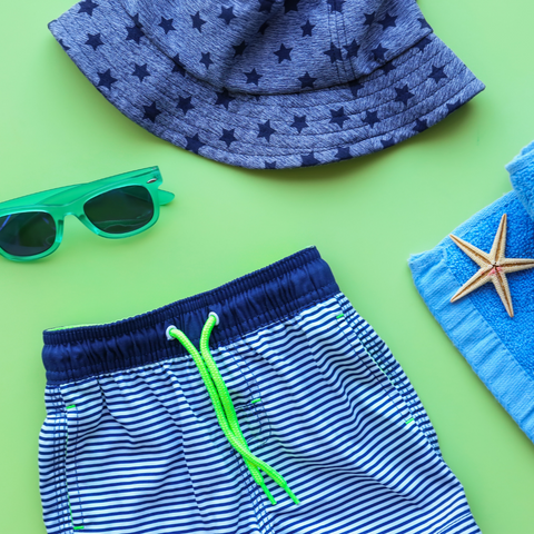 blue board-shorts, blue bucket hat, green sunglasses