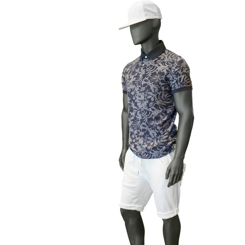 Mannequin wearing floral polo shirt and white shorts and white hat