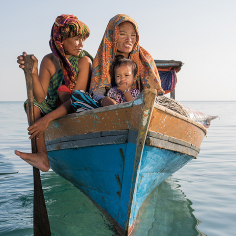 3 people from Malaysia in a blue boat