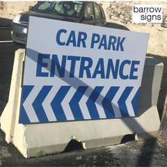 Car Park entrance sign mounted high on a precast concrete barrier