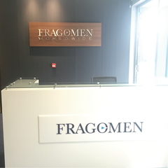 Fragomen Reception area Dublin, Ireland with Walnut Panel and Brushed Stainless Steel lettering by Barrow Signs