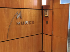 Brushed stainless steel lettering on veneered timber panel