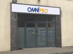 OmniPro office entrance with overhead signage and branded window manifestation