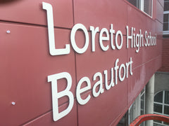CNC routed lettering in position waiting for the logo at Loreto High School by www.barrowsigns.com