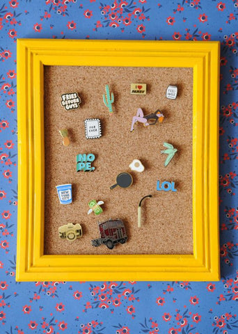 Enamel pins in a picture frame