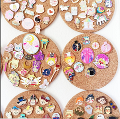 enamel pin collection on cork boards