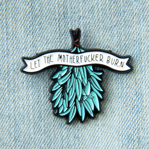 An enamel pin of a bundle of sage for smudging with a funny quote. 