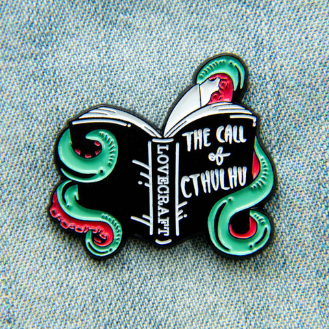 An HP Lovecraft book enamel pin. 