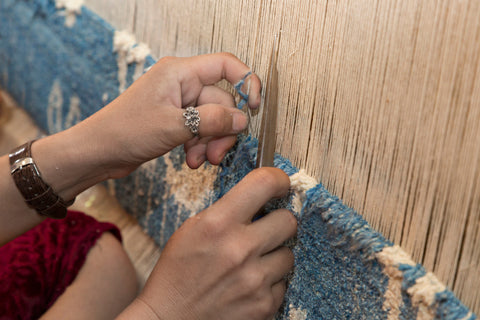 A rug being manufactured by hand