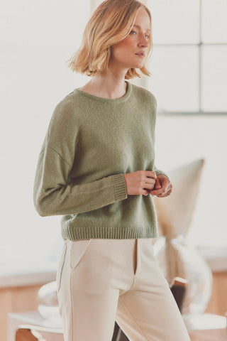 a model in a green cashmere sweater