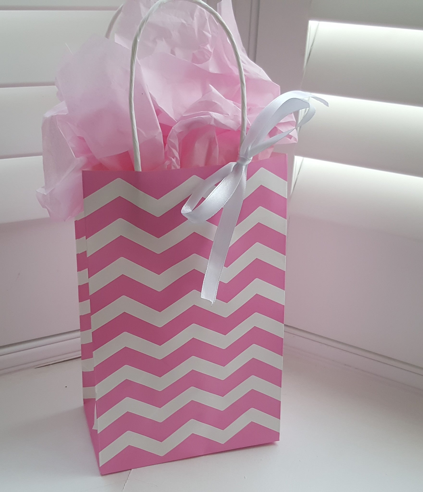 pink and white striped gift bags