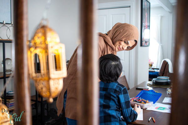 Days of Eid Founder Reem Sayes and her child coloring 