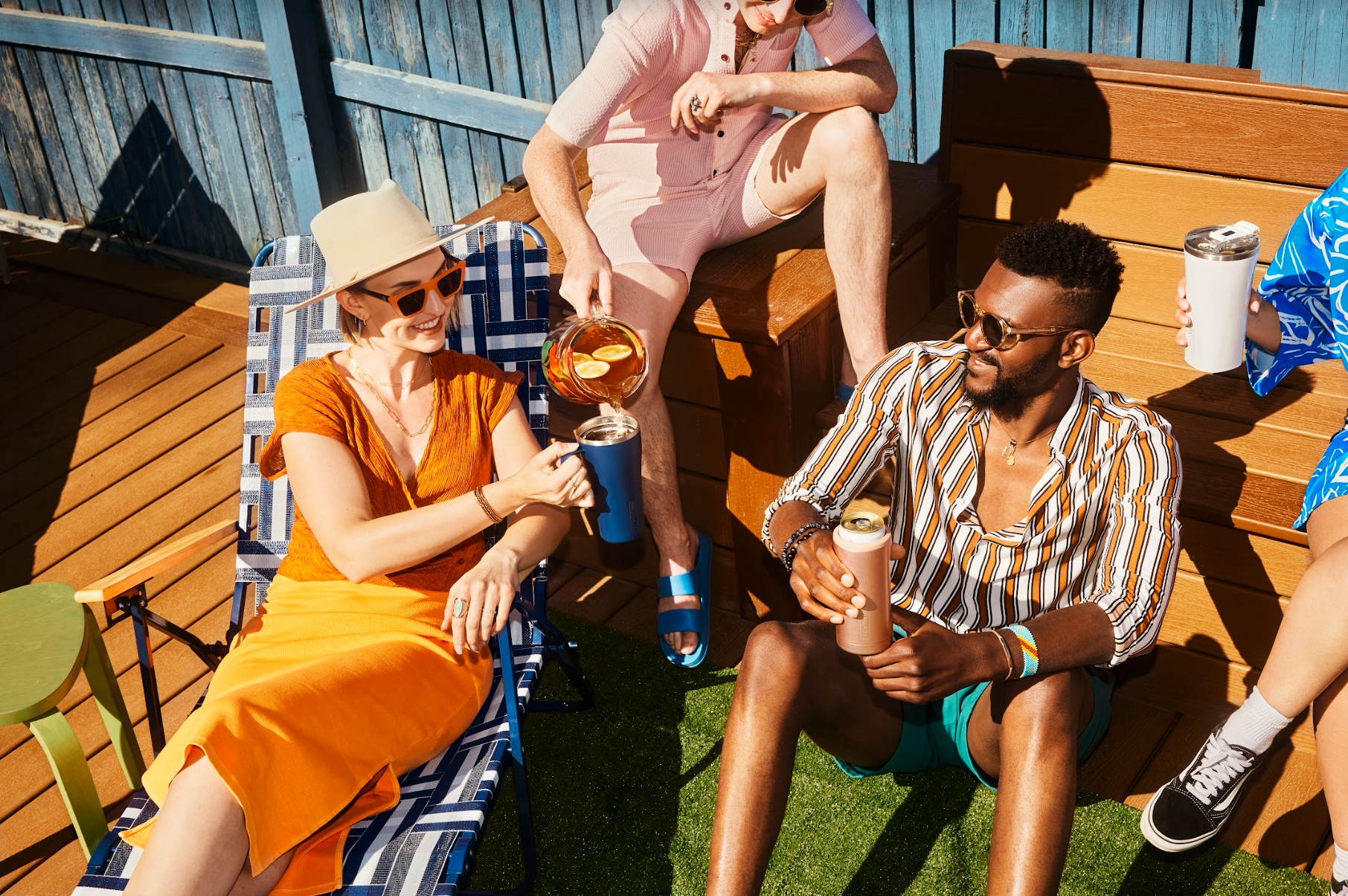 people enjoying cocktails in the sun outside.