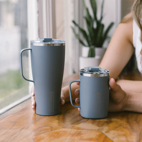 two coffee tumblers sitting next to each other.