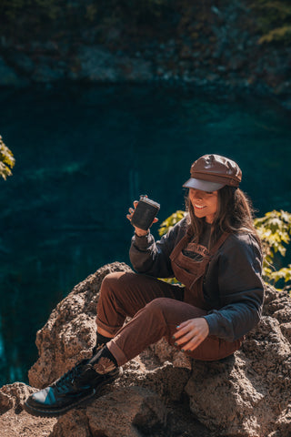 woman holding cocktail tumbler.