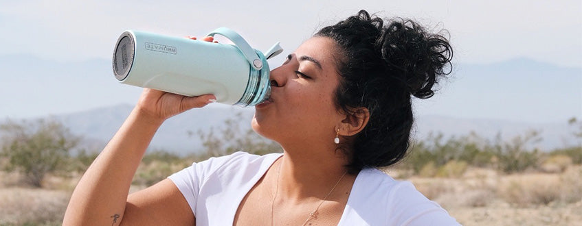 woman drinking from multishaker