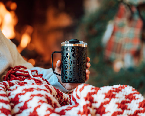 tumbler mug sitting on a blanket.