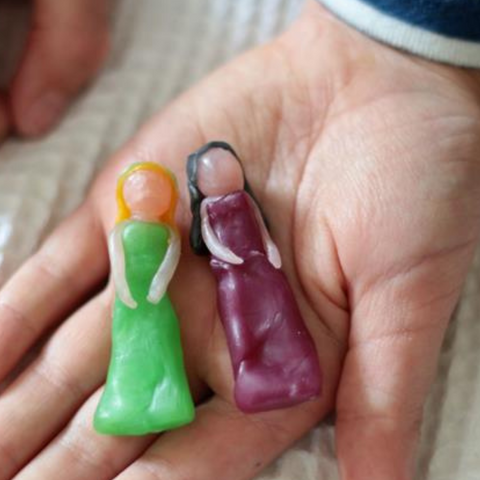 Child Holding Beeswax Figures they have made from Bella Luna Toys 