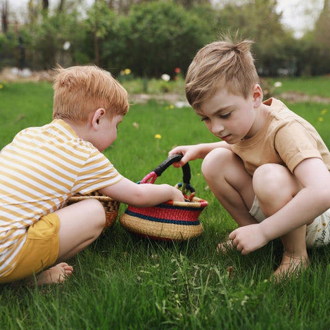 Children gathering flowers and placing in a Child's Bolga Basket from Bella Luna Toys