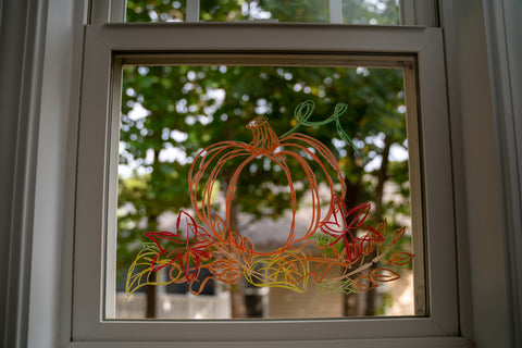 A pumpkin drawn on window for Halloween decoration with Kitpas window crayons