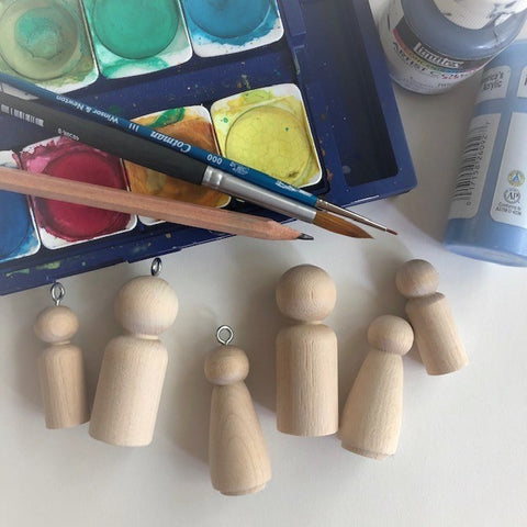 Blank peg dolls and watercolor paints for a Waldorf craft