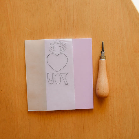 Tracing a stencil onto transfer paper to make a carved rubber stamp
