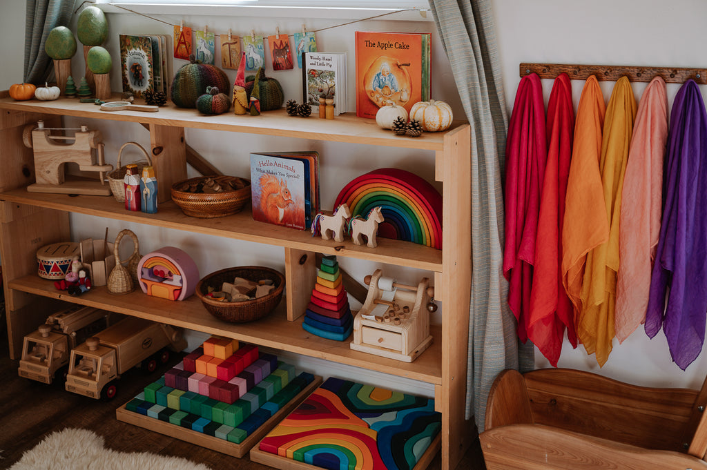 A curated toy shelf featuring Grimm's Wooden Toys and more from Bella Luna Toys