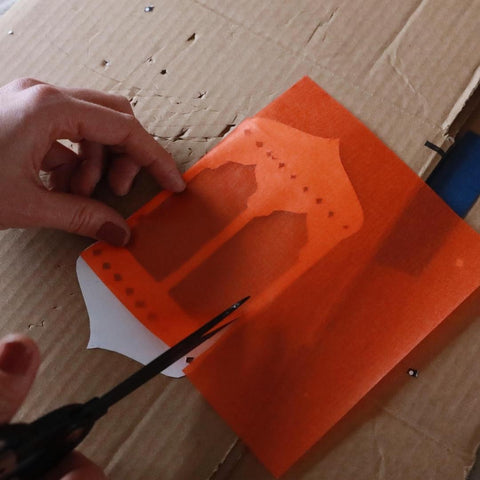 Cutting kite paper to size for a Ramadan window lantern craft