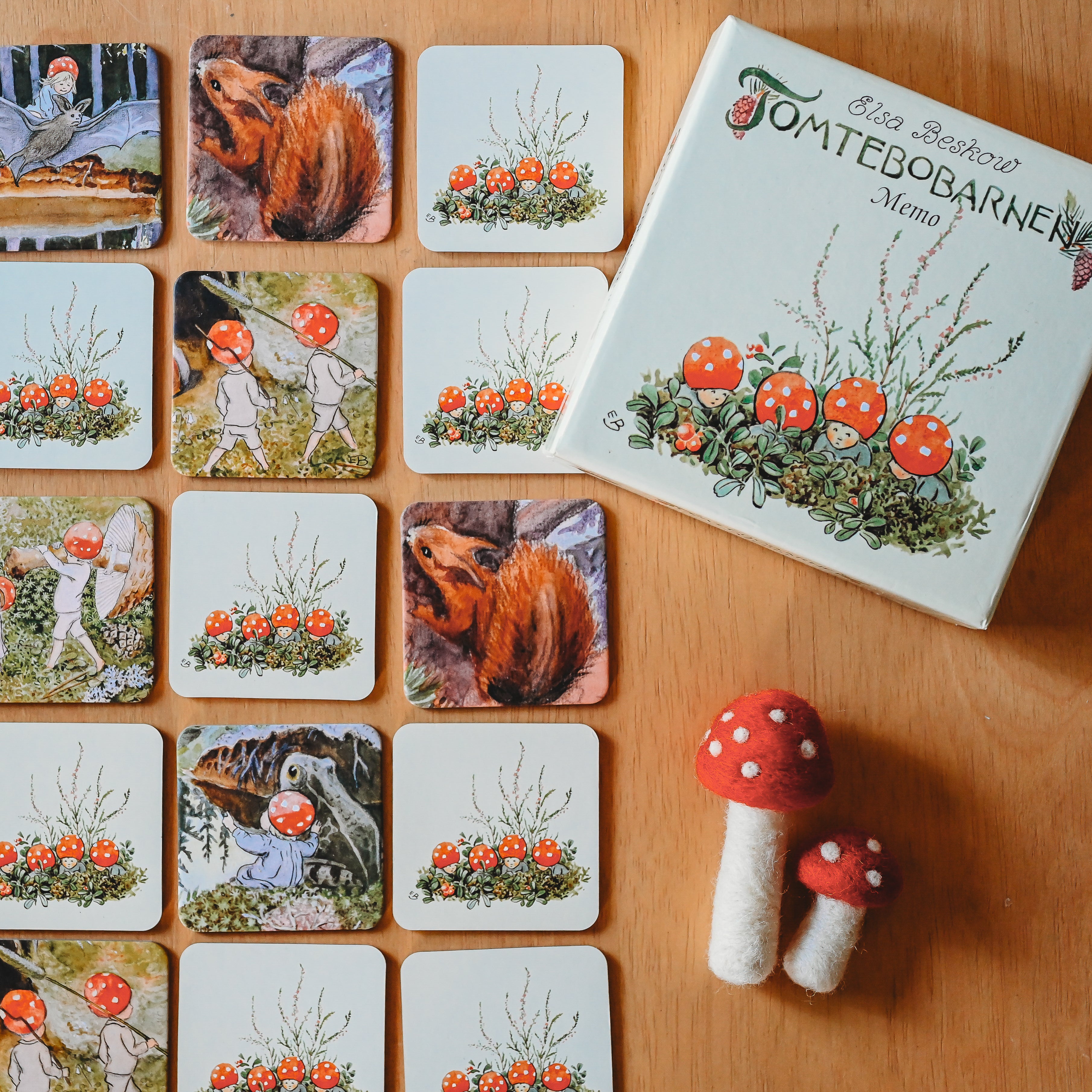 The mushroom game from Bella Luna Toys sits open on a wooden table.