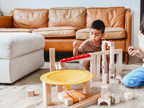 Child playing with HABA wooden marble run