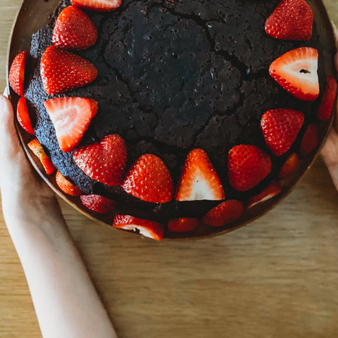 Chocolate cake topped with strawberry slices