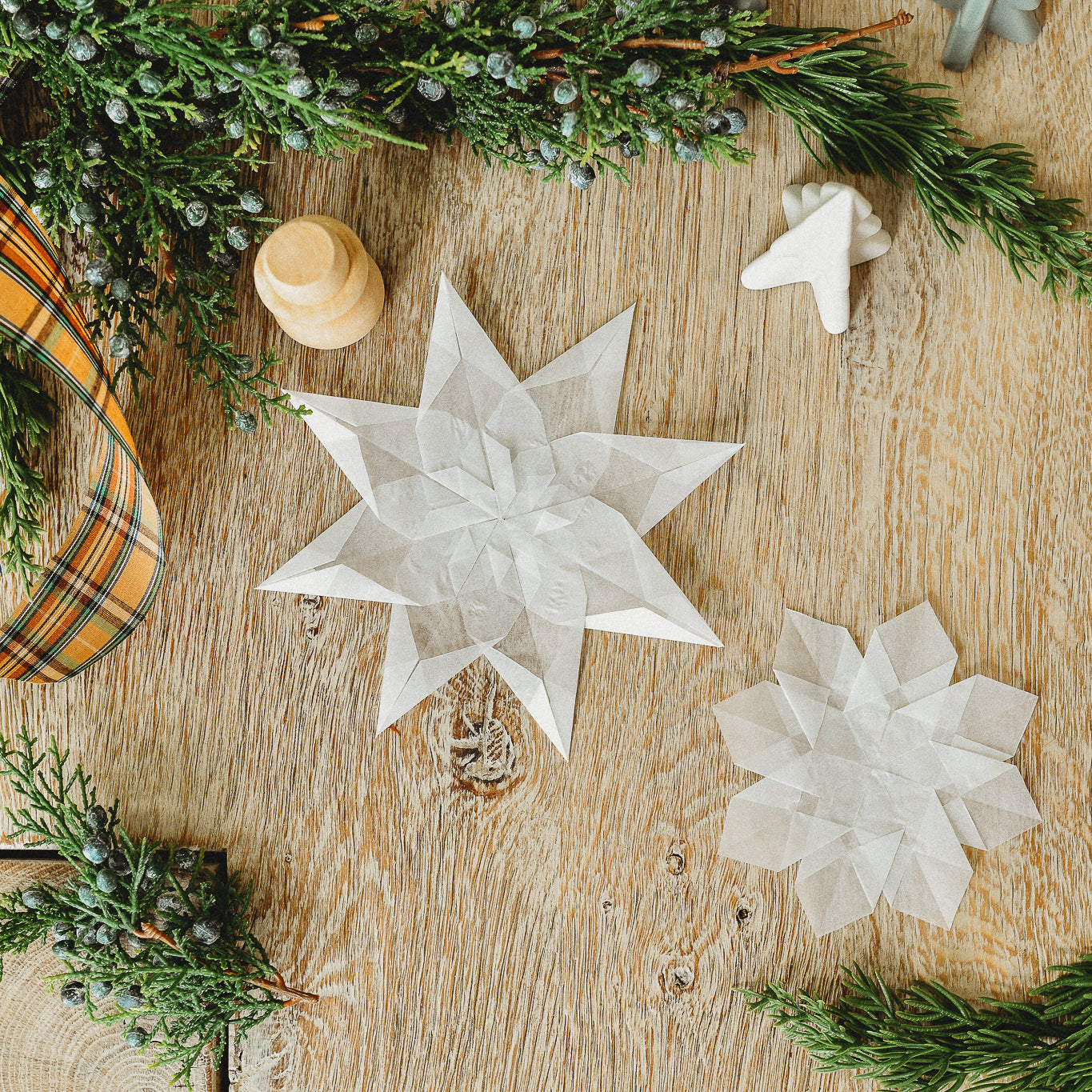 Window snowflakes sit on a table.