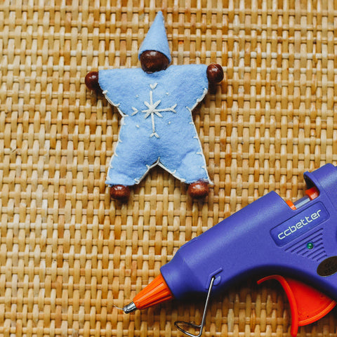 A hot glue gun used to glue on the wooden beads and hat to complete the felt waldorf snowflake children.