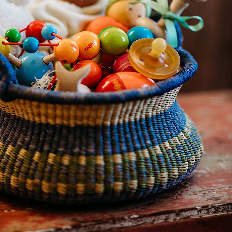 A crafted bolga basket sits filled with goodies.