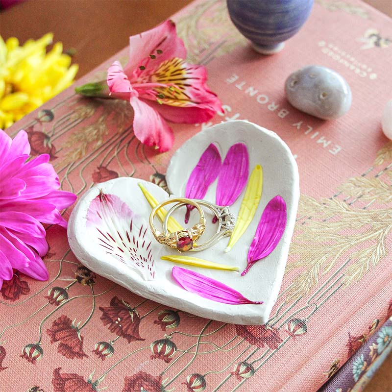 Two rings sit in a trinket dish.