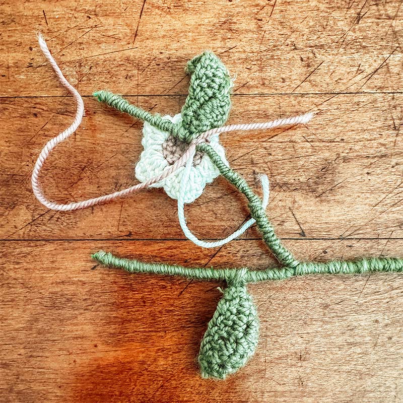 Crochet flower being sewn