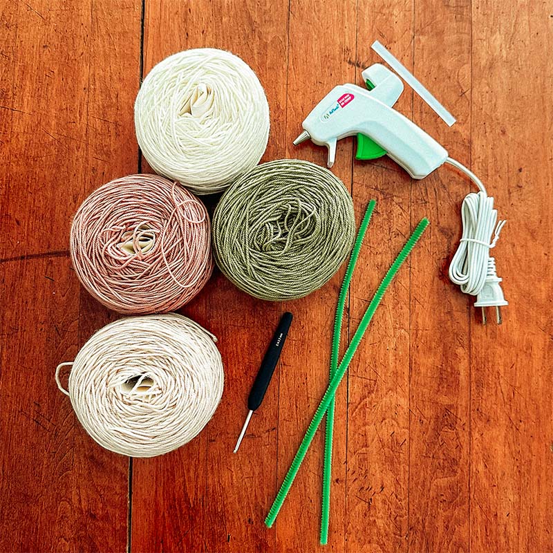 A collection of crafting supplies sit on a table.