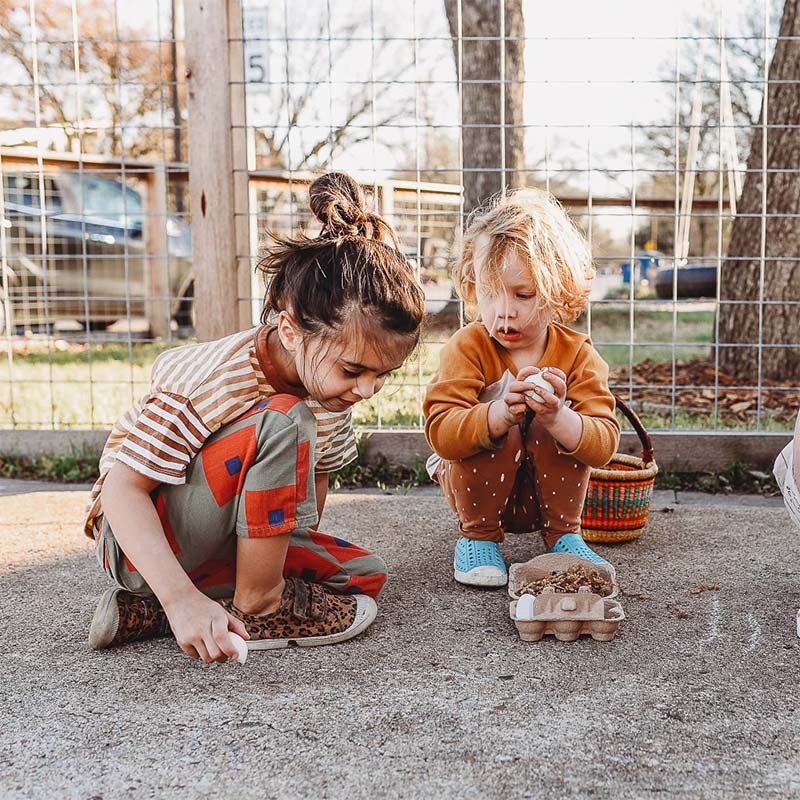 two kids are playing Waldorf inspired recess games