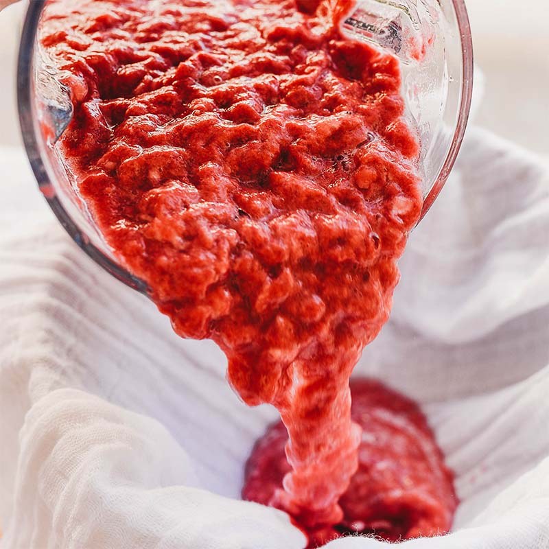 Paper pulp is being poured into a bowl.