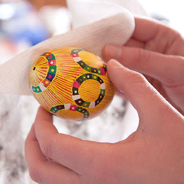 Removing wax from one of the pysanky eggs | Bella Luna Toys